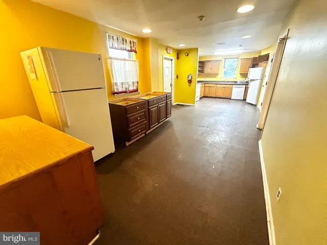 a view of a kitchen with a refrigerator a sink and a refrigerator