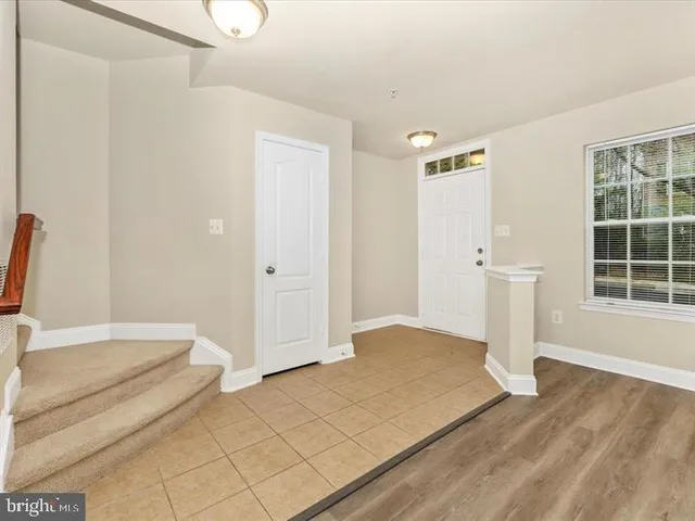 a view of a livingroom with wooden floor and entryway