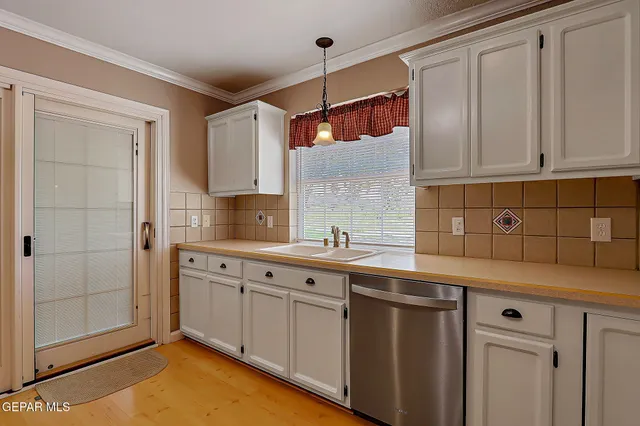 a kitchen with a sink and cabinets