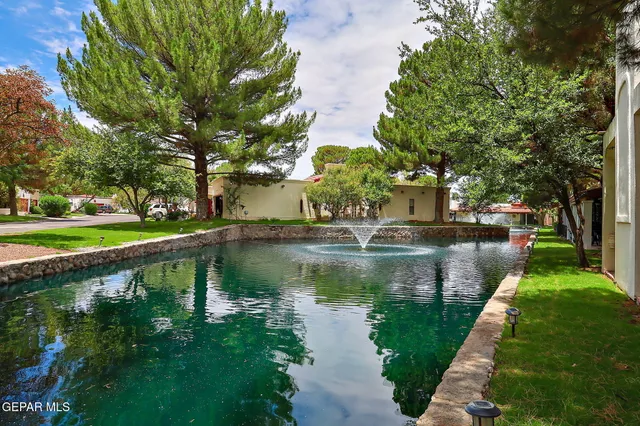 a view of a lake with a house in the background