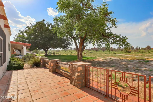 a view of a pathway with a wrought fence