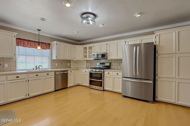 a kitchen with granite countertop stainless steel appliances and white cabinets