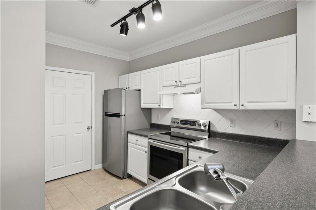 4102 Westchester Ridge Northeast Atlanta, GA 30329 - Photo 12 of 39 a kitchen with stainless steel appliances granite countertop a sink stove and refrigerator