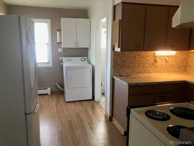 2909 Chase Street Wheat Ridge, CO 80214 - Photo 8 of 17 a kitchen with a refrigerator and a stove