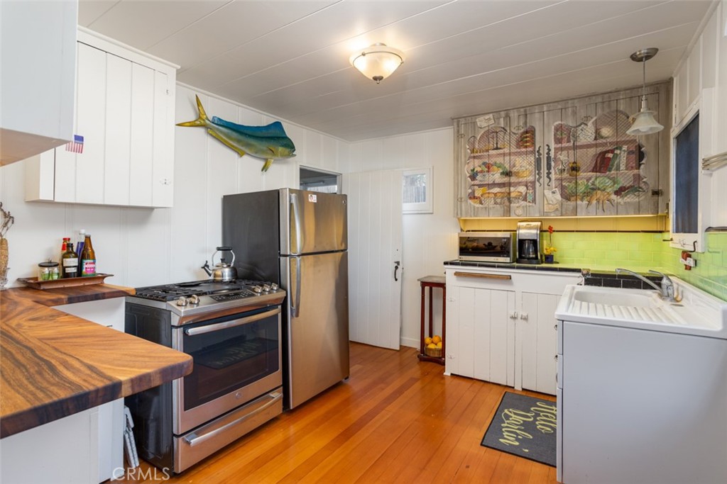 856 Cliff Drive Laguna Beach, CA 92651 - Photo 12 of 28 a kitchen with a stove and a refrigerator