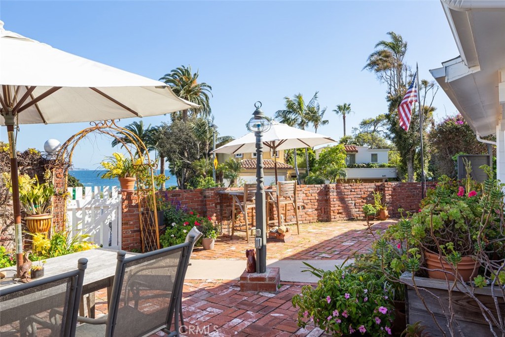 856 Cliff Drive Laguna Beach, CA 92651 - Photo 23 of 28 a view of a fountain with a bench in patio