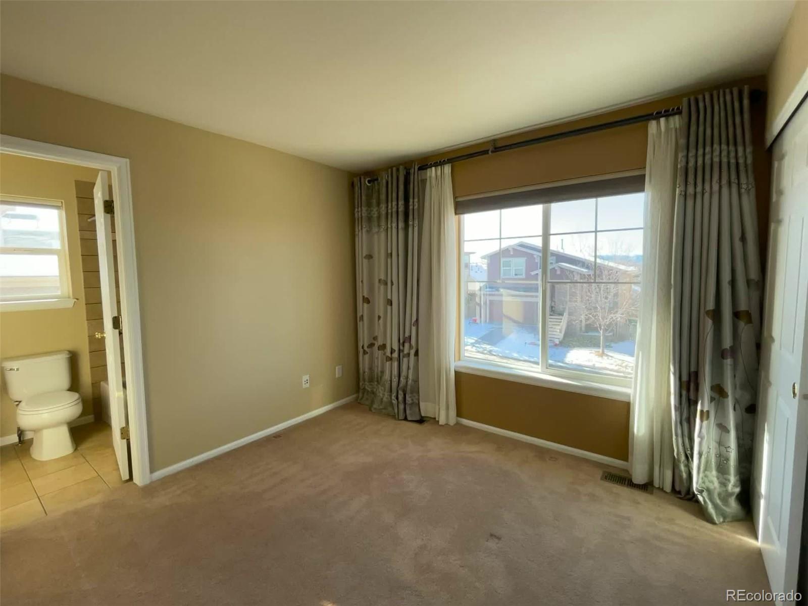 10838 Towerbridge Road Highlands Ranch, CO 80130 - Photo 12 of 26 a view of an empty room with a window
