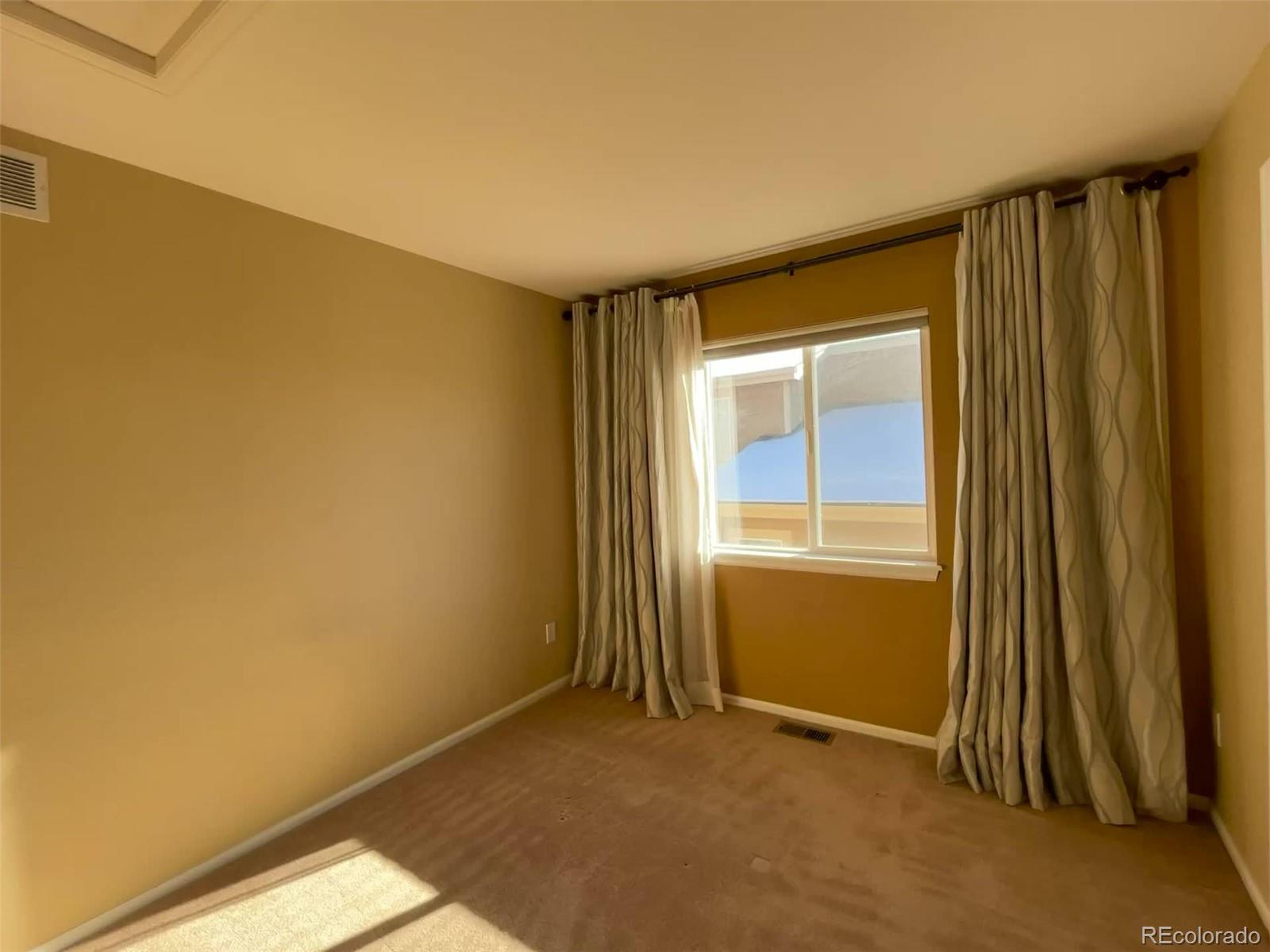 10838 Towerbridge Road Highlands Ranch, CO 80130 - Photo 13 of 26 an empty room with windows