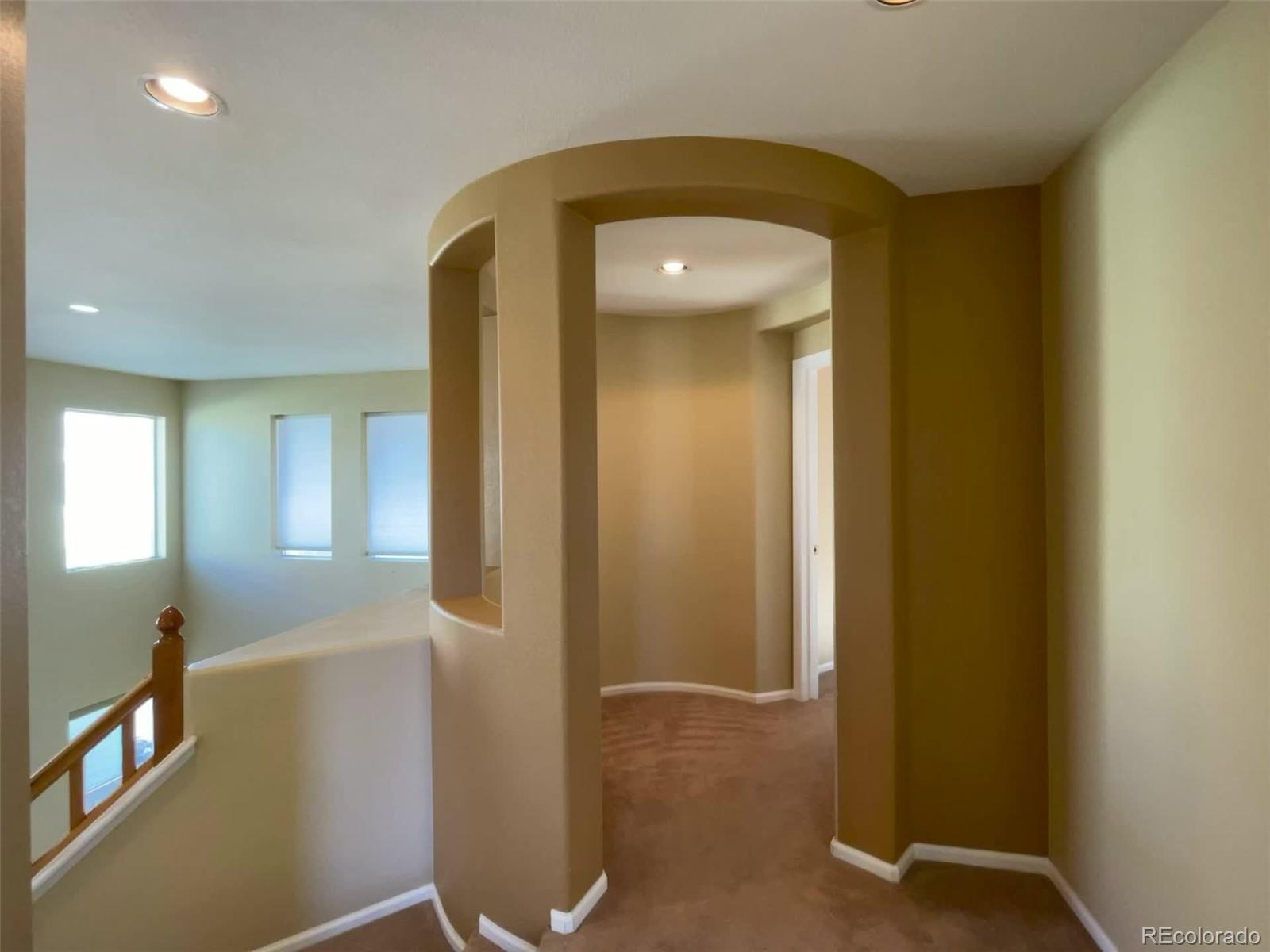 10838 Towerbridge Road Highlands Ranch, CO 80130 - Photo 14 of 26 a view of a hallway with wooden floor