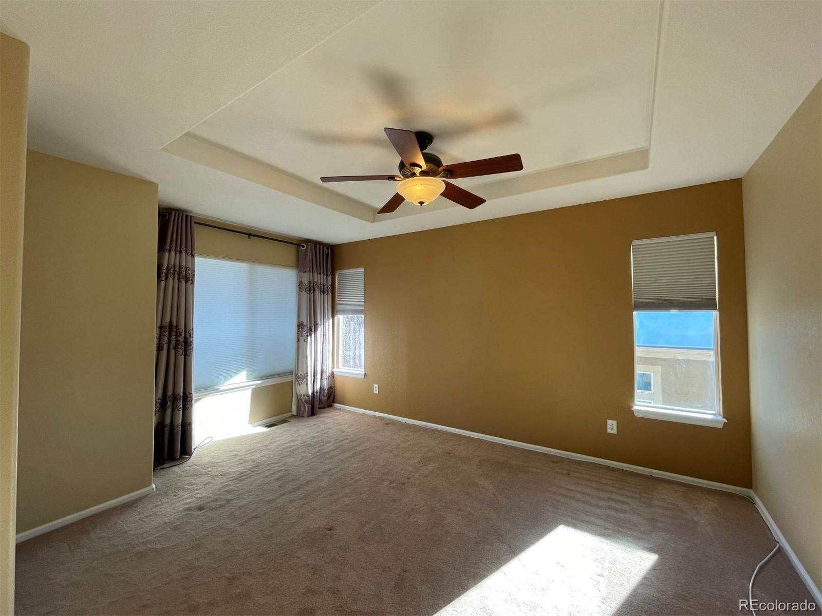 10838 Towerbridge Road Highlands Ranch, CO 80130 - Photo 15 of 26 a view of a livingroom with a ceiling fan and window