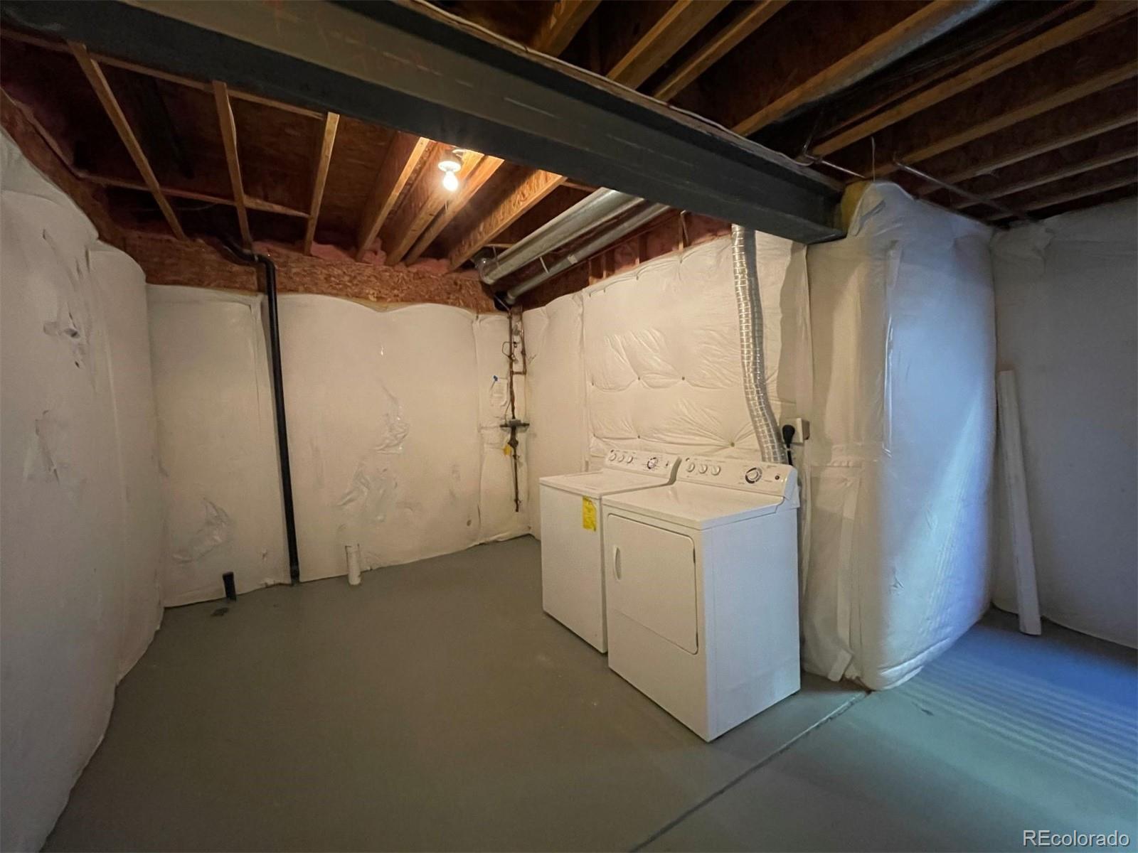 10838 Towerbridge Road Highlands Ranch, CO 80130 - Photo 19 of 26 a utility room with dryer and washer