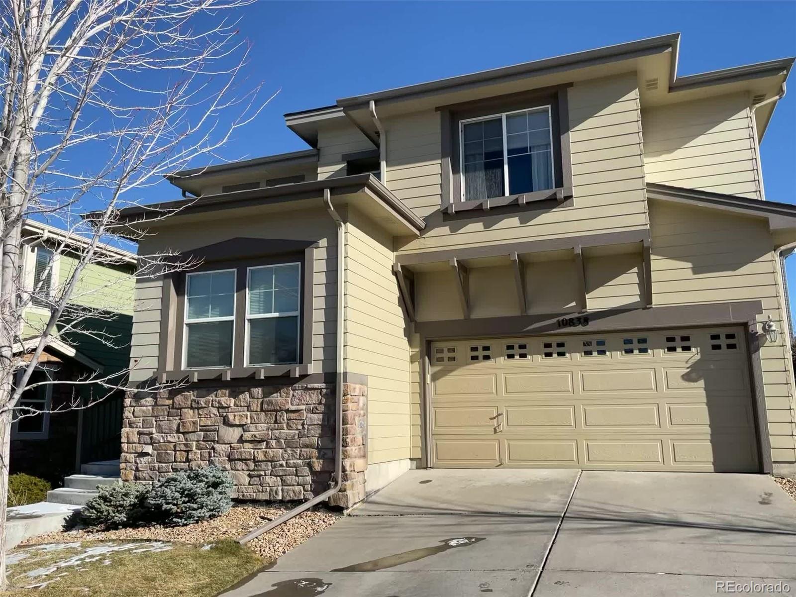 10838 Towerbridge Road Highlands Ranch, CO 80130 - Photo 2 of 26 a view of a house with brick walls