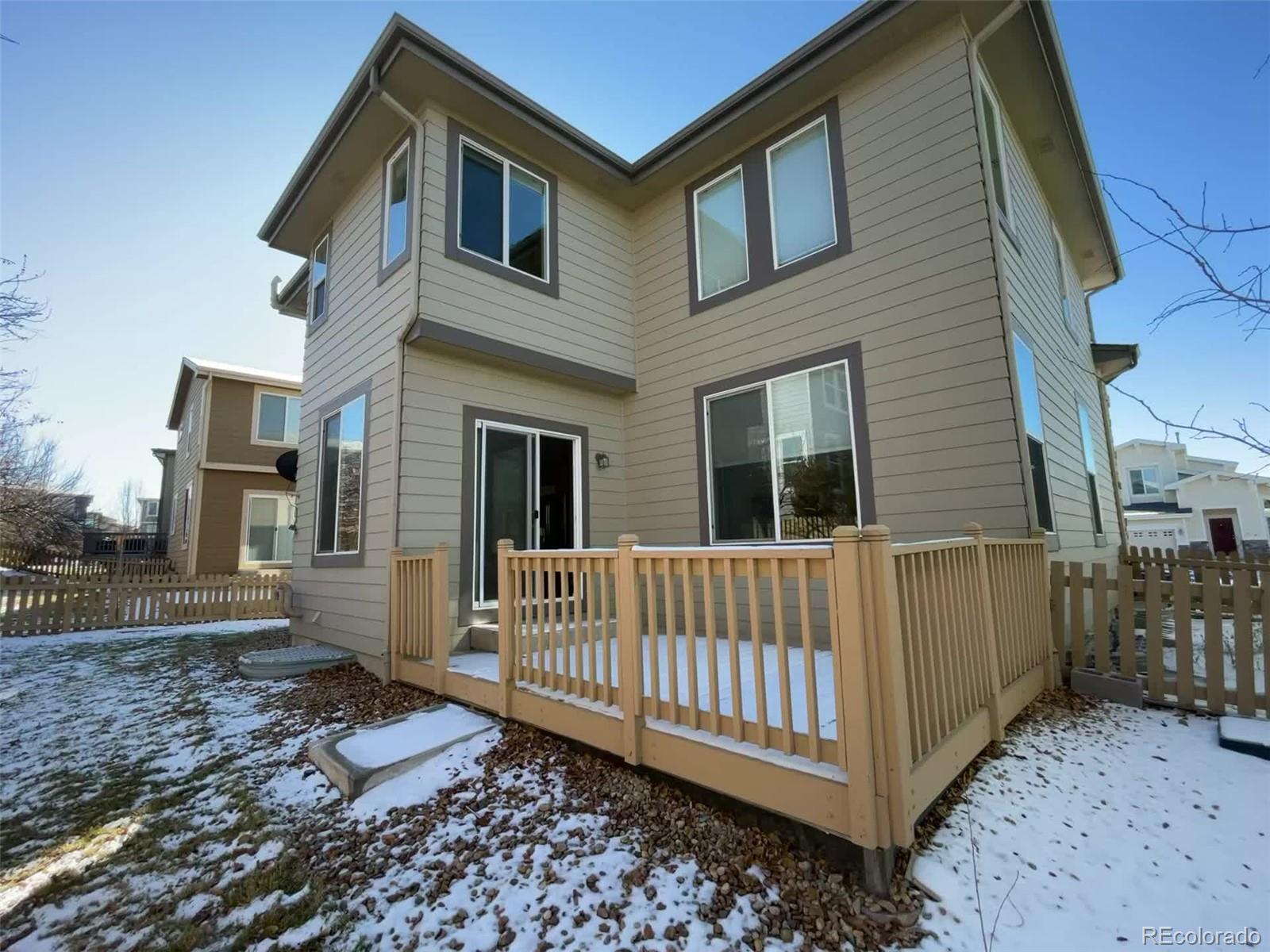 10838 Towerbridge Road Highlands Ranch, CO 80130 - Photo 23 of 26 a view of a house with a yard