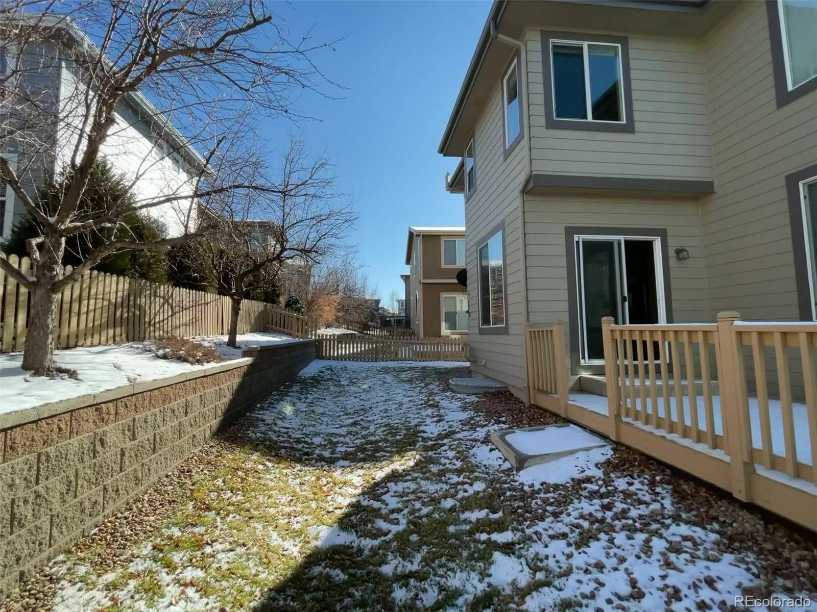 10838 Towerbridge Road Highlands Ranch, CO 80130 - Photo 24 of 26 a view of a house with a yard