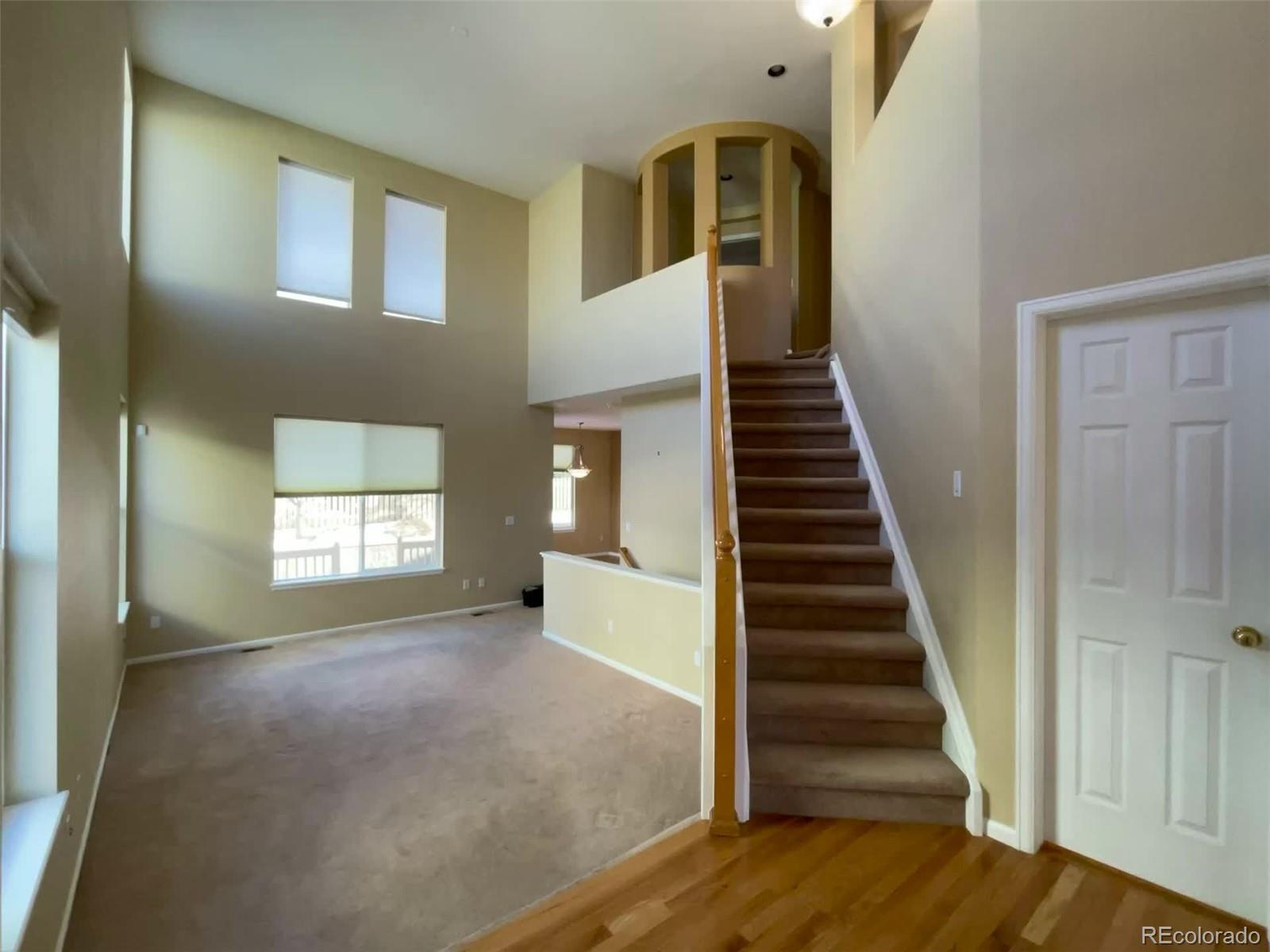 10838 Towerbridge Road Highlands Ranch, CO 80130 - Photo 8 of 26 a view of entryway and hall with wooden floor