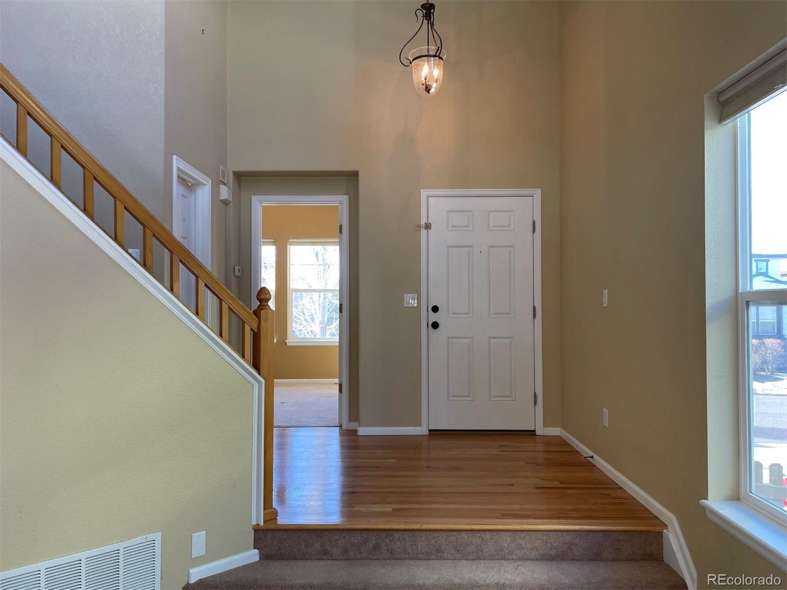 10838 Towerbridge Road Highlands Ranch, CO 80130 - Photo 10 of 26 a view of entryway and hall with wooden floor