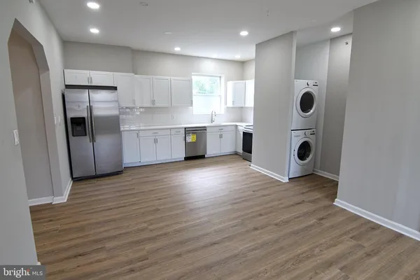 a view of kitchen with stainless steel appliances refrigerator microwave and stove