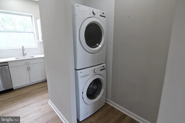 a utility room with sink dryer and washer