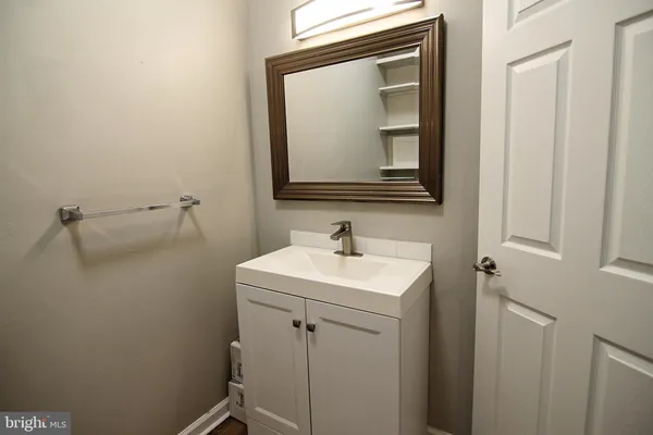 a bathroom with a sink a mirror and vanity
