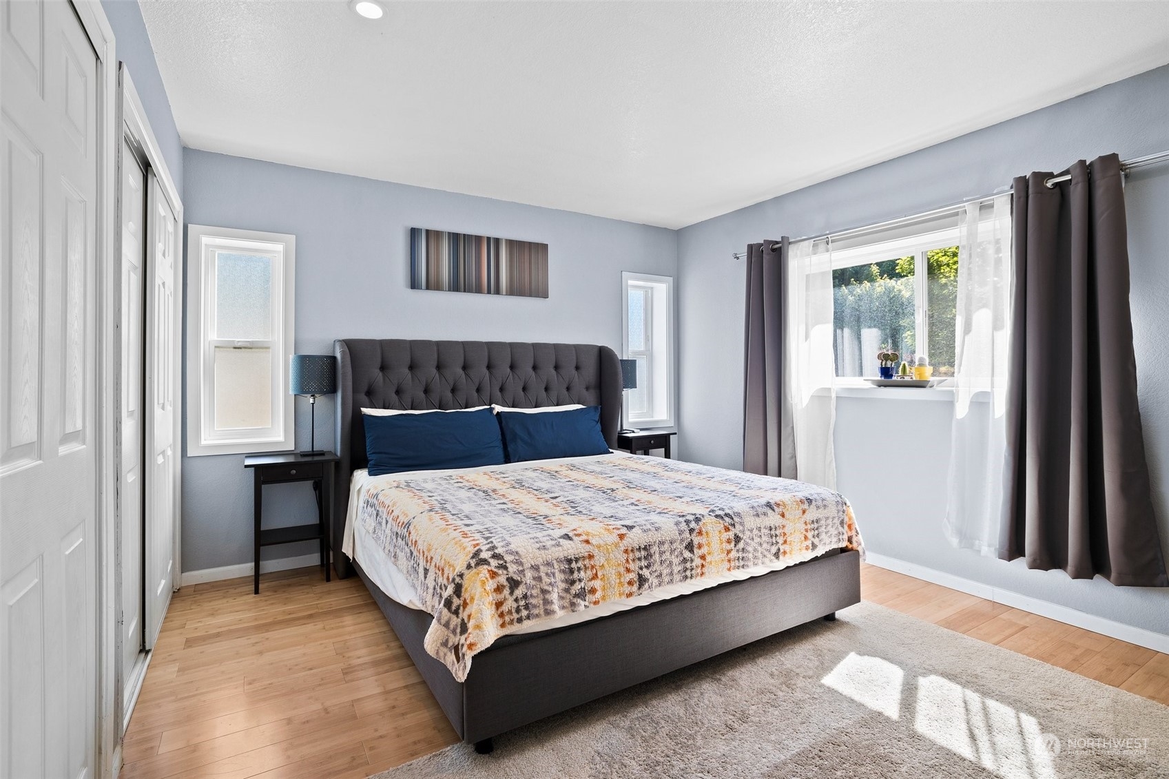 7222 16th Avenue Southwest Seattle, WA 98106 - Photo 18 of 31 a bedroom with a large bed and a window