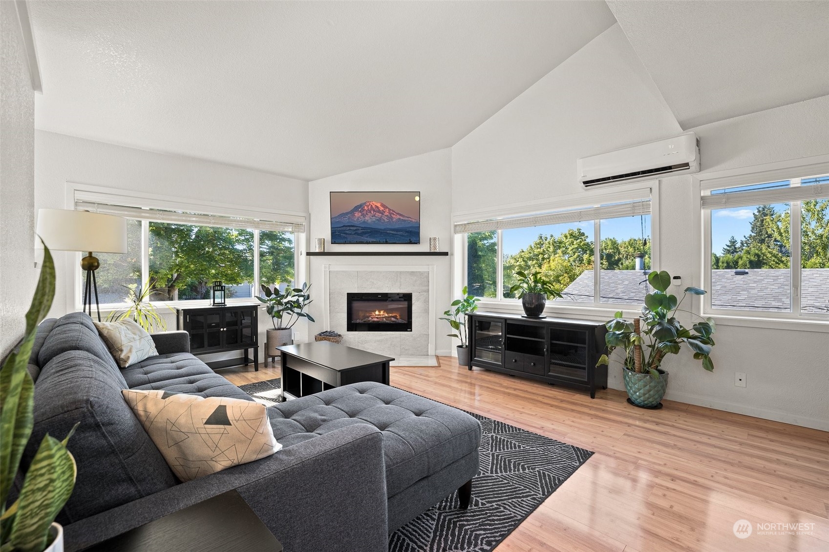 7222 16th Avenue Southwest Seattle, WA 98106 - Photo 3 of 31 a living room with furniture a fireplace and a floor to ceiling window