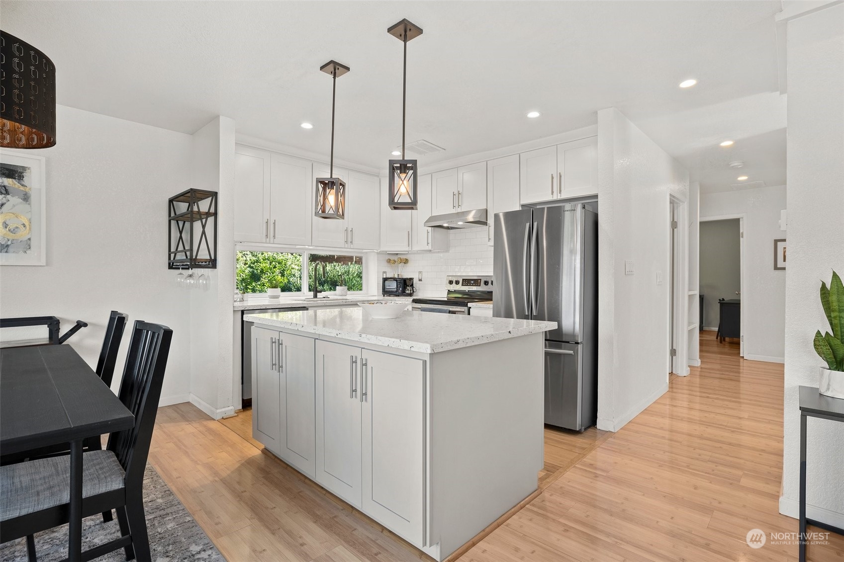 7222 16th Avenue Southwest Seattle, WA 98106 - Photo 9 of 31 a kitchen with white cabinets and refrigerator