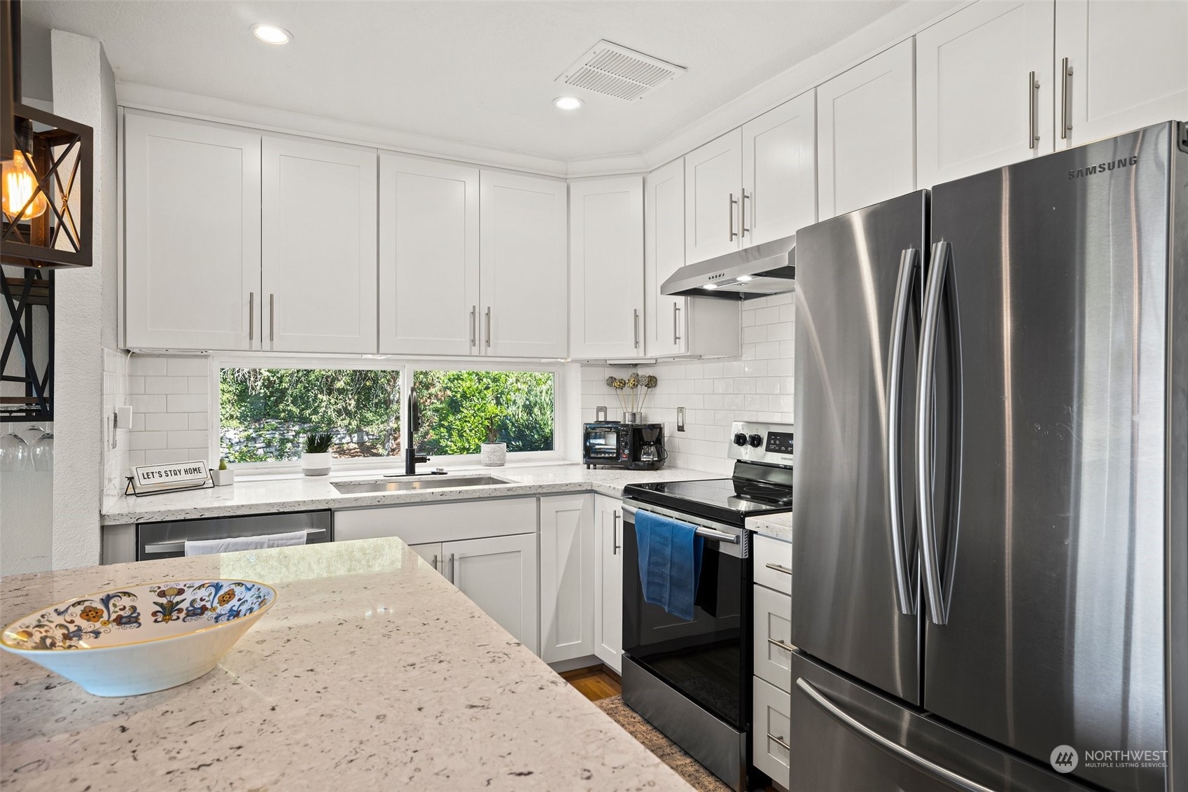 7222 16th Avenue Southwest Seattle, WA 98106 - Photo 10 of 31 a kitchen with stainless steel appliances granite countertop a refrigerator sink and stove