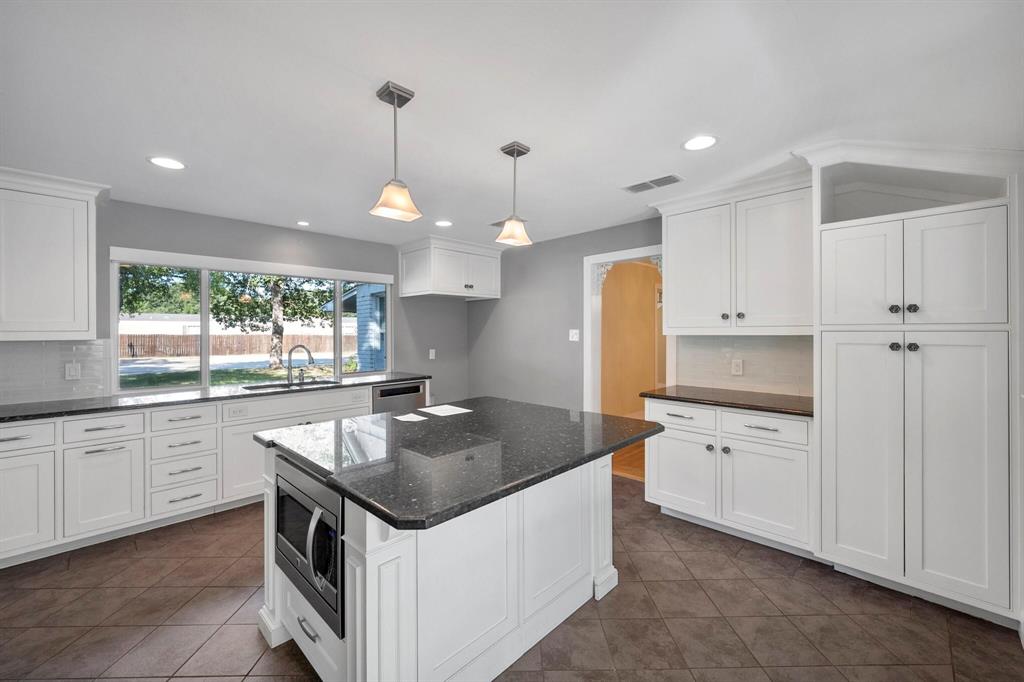 1512 Cardinal Road Mansfield, TX 76063 - Photo 11 of 37 a kitchen that has a sink a stove and a microwave