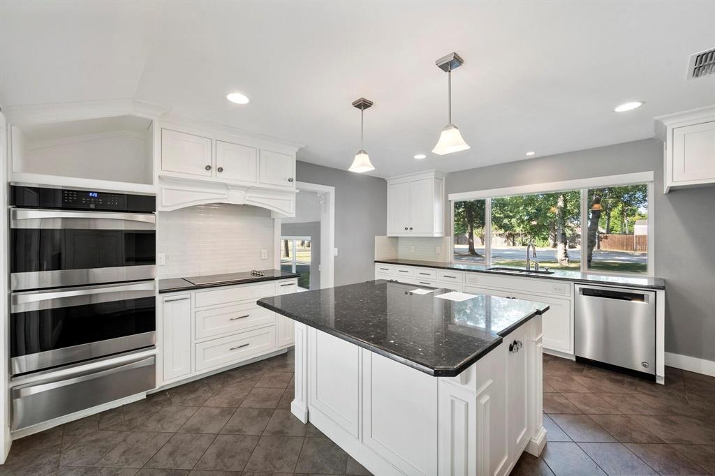 1512 Cardinal Road Mansfield, TX 76063 - Photo 12 of 37 a kitchen with granite countertop a sink and stove top oven