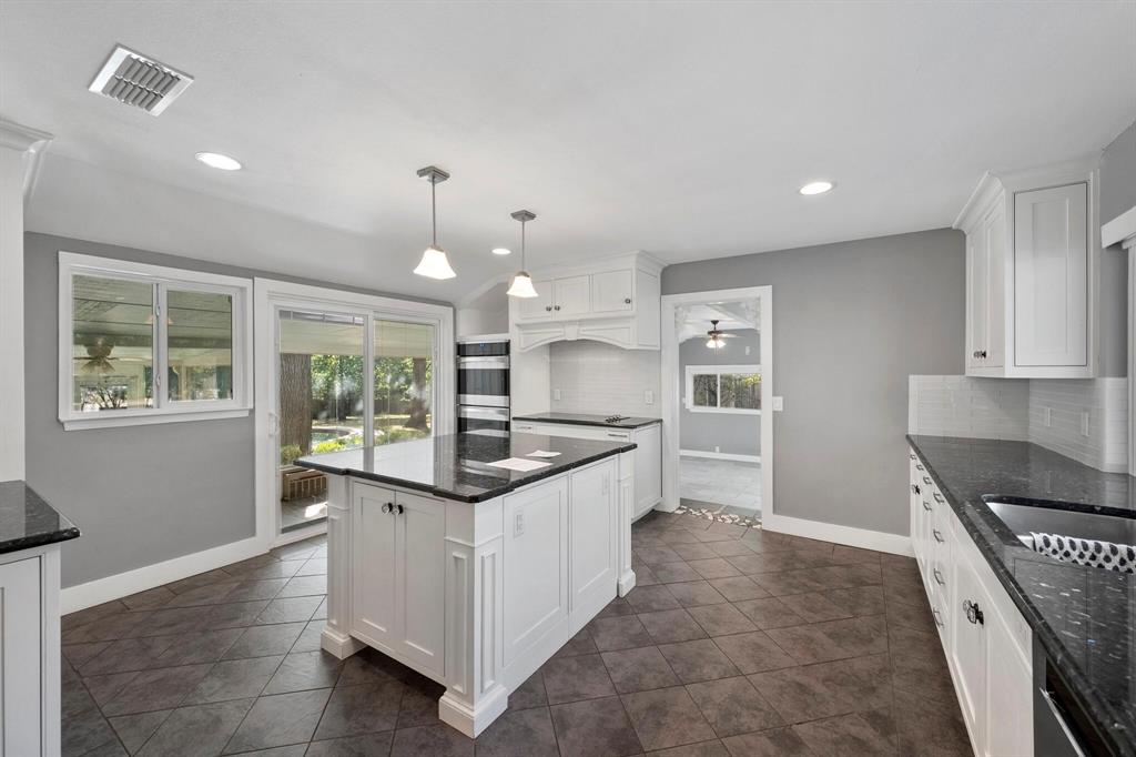 1512 Cardinal Road Mansfield, TX 76063 - Photo 13 of 37 a kitchen with stainless steel appliances granite countertop a stove and a sink