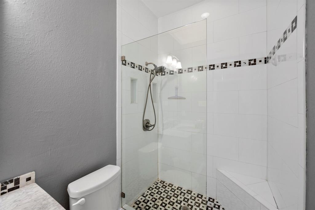 1512 Cardinal Road Mansfield, TX 76063 - Photo 22 of 37 a bathroom with a shower a toilet and sink