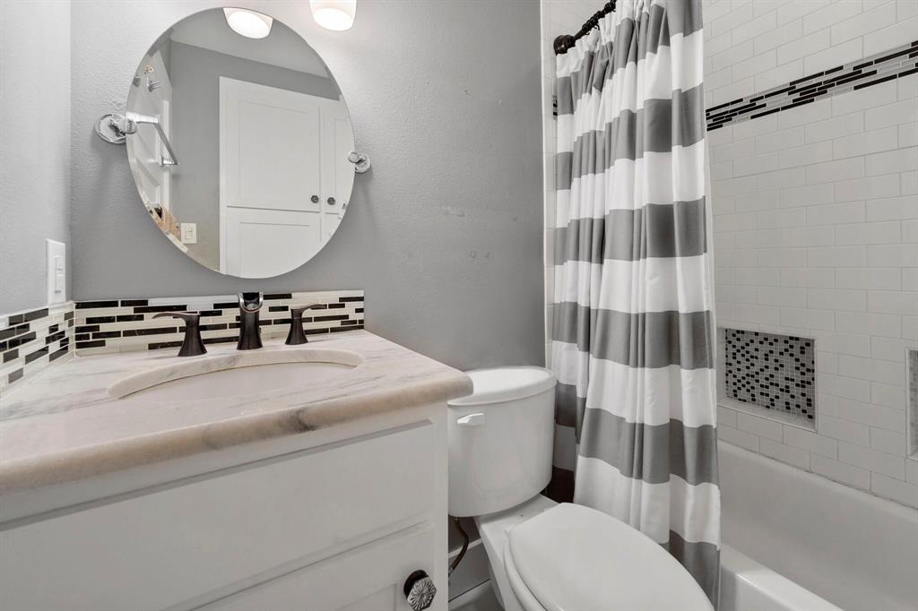 1512 Cardinal Road Mansfield, TX 76063 - Photo 23 of 37 a bathroom with a sink a toilet a mirror and shower