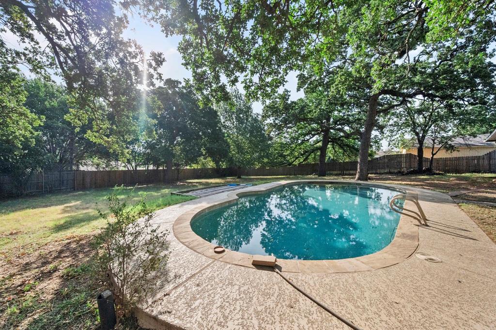 1512 Cardinal Road Mansfield, TX 76063 - Photo 32 of 37 a view of a swimming pool with a yard and plants