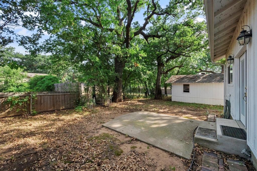 1512 Cardinal Road Mansfield, TX 76063 - Photo 37 of 37 a view of a backyard with a tree