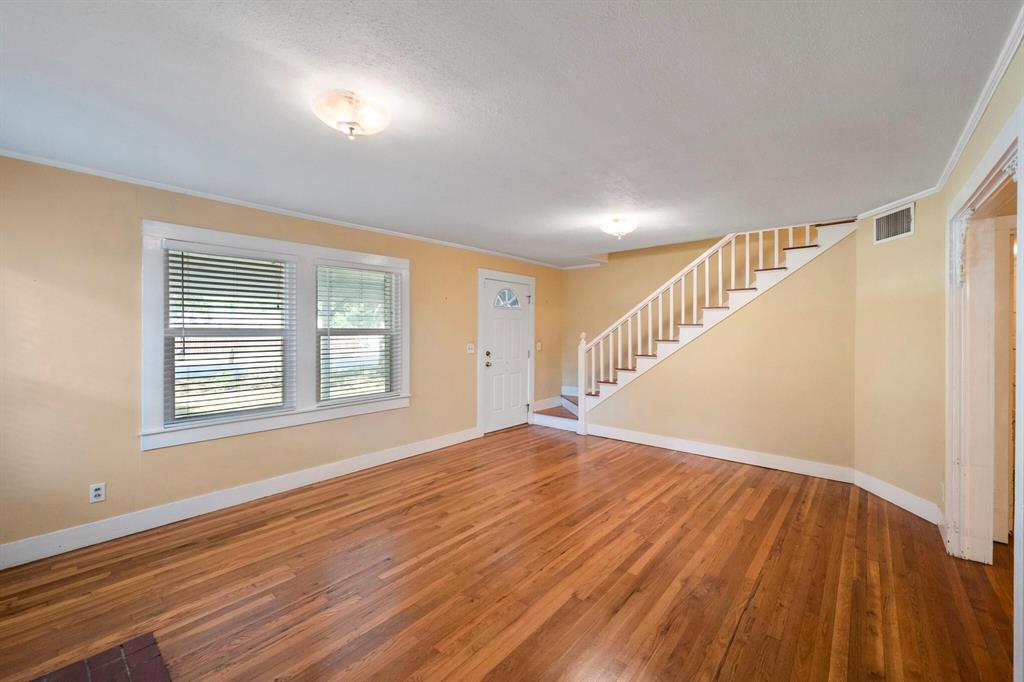 1512 Cardinal Road Mansfield, TX 76063 - Photo 7 of 37 a view of an empty room with wooden floor and a window
