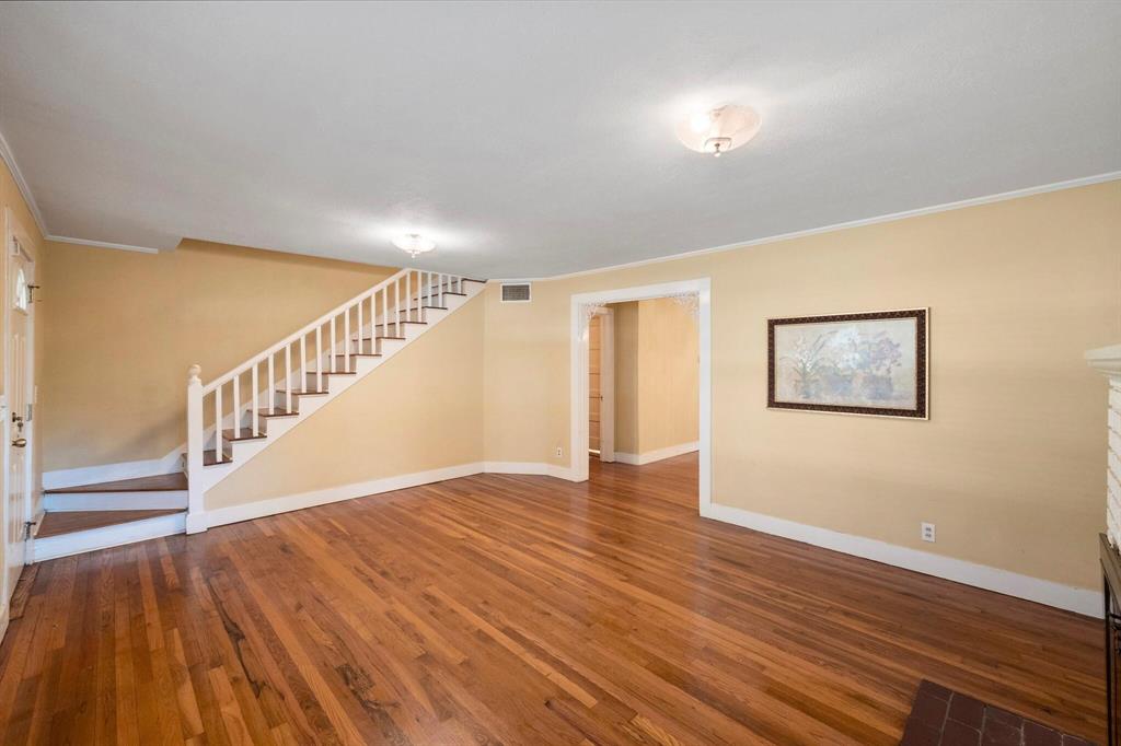 1512 Cardinal Road Mansfield, TX 76063 - Photo 10 of 37 a view of an empty room with wooden floor and stairs
