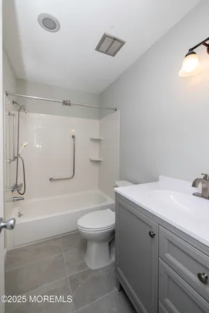 a bathroom with a sink a toilet and a shower