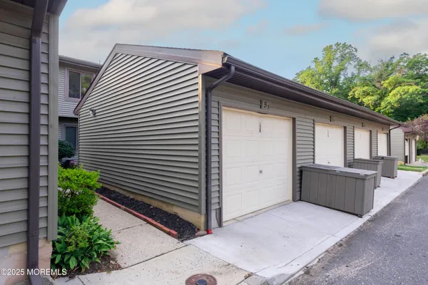 a front view of a house with plants