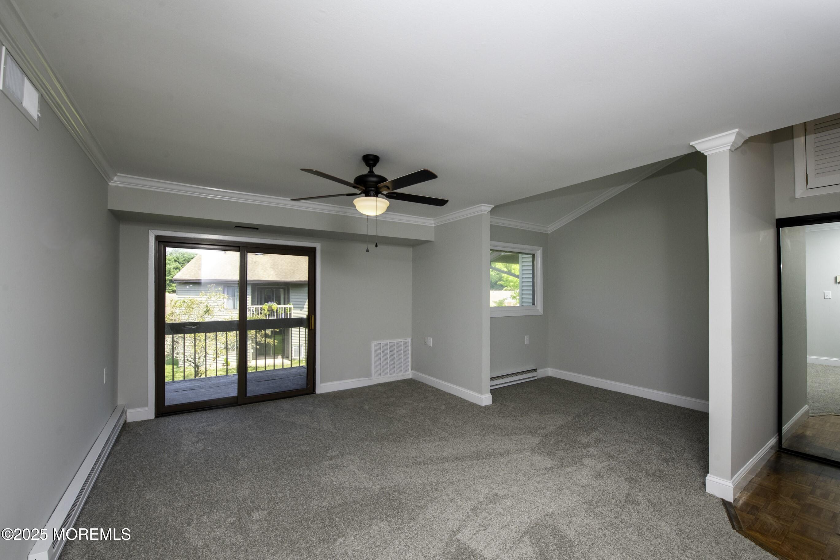 5 B Auburn Court Red Bank, NJ 07701 - Photo 5 of 19 an empty room with windows and ceiling fan