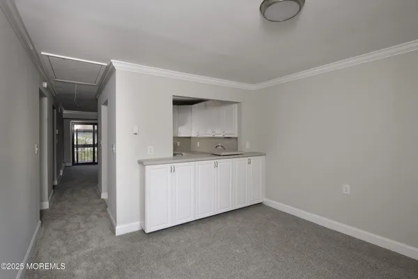 a room with a sink and cabinets