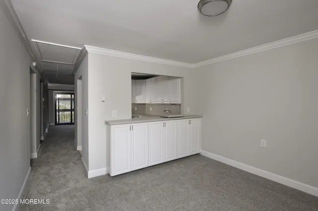 a room with a sink and cabinets
