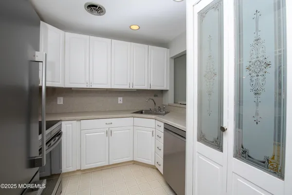 a kitchen with a sink and cabinets