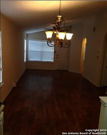 a view of a livingroom with furniture wooden floor and chandelier