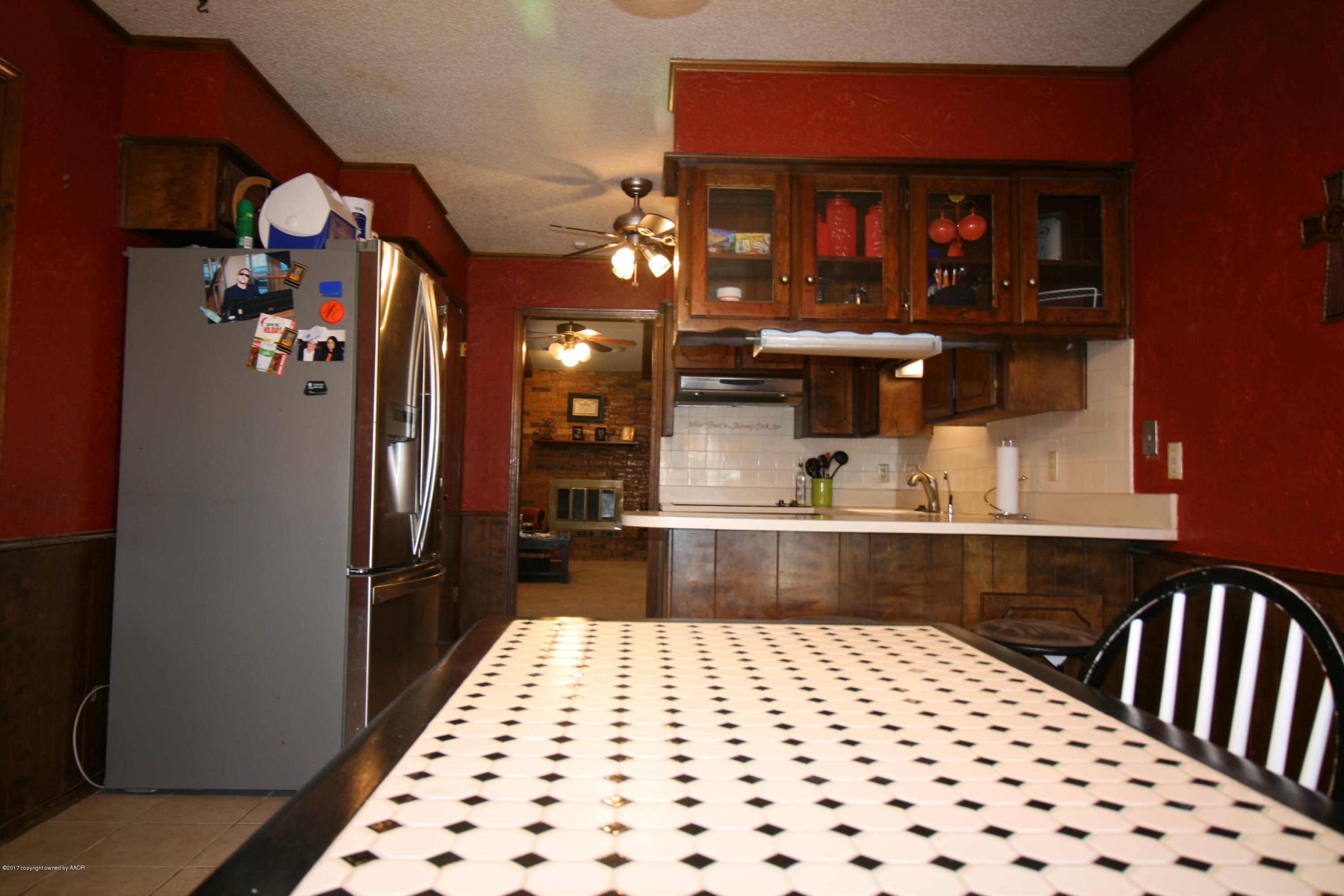 5710 South Milam Street Amarillo, TX 79110 - Photo 6 of 21 a kitchen with stainless steel appliances kitchen island granite countertop a refrigerator and a sink