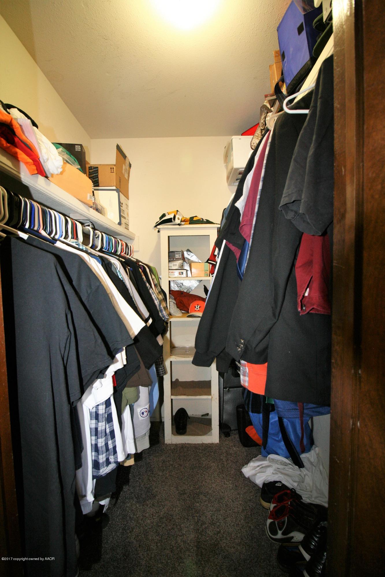 5710 South Milam Street Amarillo, TX 79110 - Photo 9 of 21 a view of walk in closet with clothes and shoes
