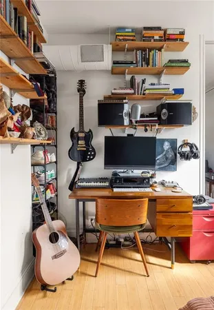 a living room with furniture and a book shelf