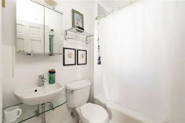 a white toilet sitting next to a bathroom sink