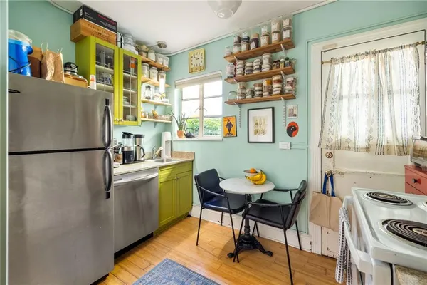 a kitchen with stainless steel appliances granite countertop a stove a microwave and wooden cabinets