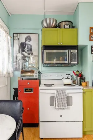 a view of a balcony with chairs and a potted plant