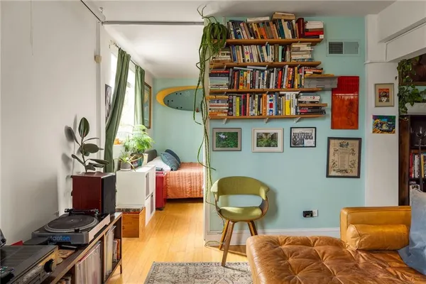 a living room with furniture cabinets and a book shelf